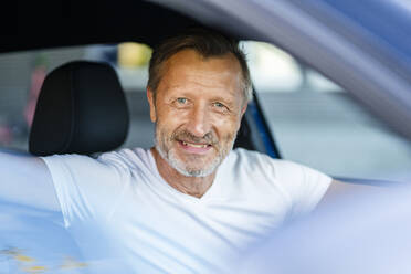 Smiling man traveling in car - DIGF20899