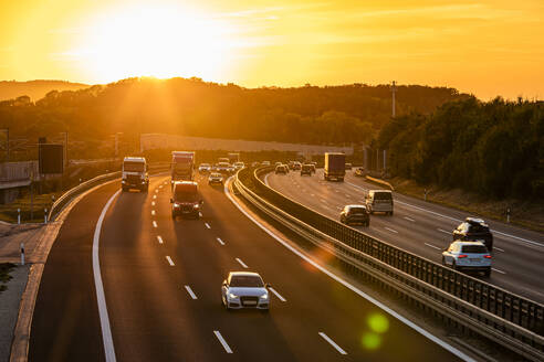 Deutschland, Baden-Württemberg, Kirchheim unter Teck, Verkehr auf der Bundesautobahn 8 bei Sonnenuntergang - WDF07417