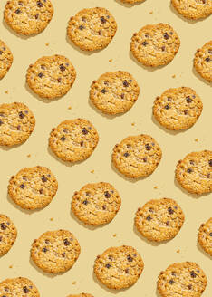 Raisin cookies arranged against yellow background - FLMF01029