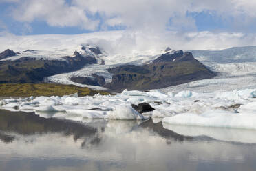 Iceland, Icebergs in Fjallsarlon lake with Vatnajokull glacier in background - RUEF04163