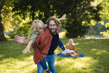 Father enjoying with son in park - JOSEF21492