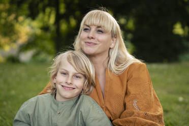 Lächelnde blonde Frau mit Sohn im Park - JOSEF21495