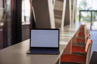 Laptop on table in office cafeteria - JOSEF21614