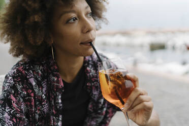 Thoughtful young woman drinking at bar - BOYF02007