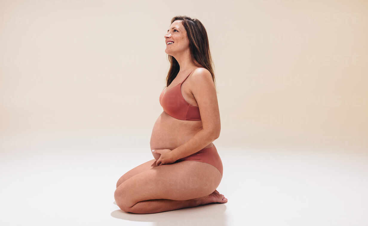 Personal Perspective Of A Pregnant Woman Wearing A Spotted Bra High-Res  Stock Photo - Getty Images