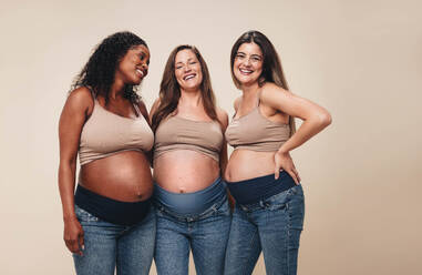 Pregnant woman holding headphones on her belly. Stock Photo by  ©stock.sokolov.com.ua 323986988