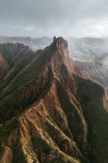 From above drone view of ancient ruined castle mountain peak above clouds on foggy day in Toledo in Spain - ADSF48649