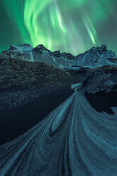 Mountainous cliff under blue sky with green aurora borealis white edge of rocky mountains under blue sky - ADSF48674