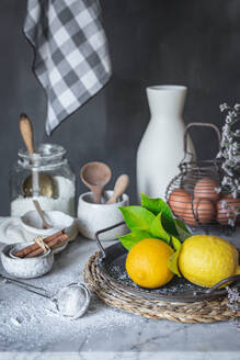 Ceramic bowls and vase near napkin placed on marble table against gray background at rustic kitchen - ADSF48710