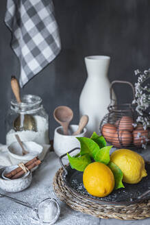 Ceramic bowls and vase near napkin placed on marble table against gray background at rustic kitchen - ADSF48711