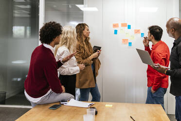 Business colleagues planning together in meeting at office - PBTF00365