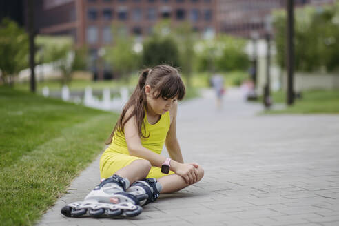 Girl falling and injuring herself roller skating at the city park - HAPF03414