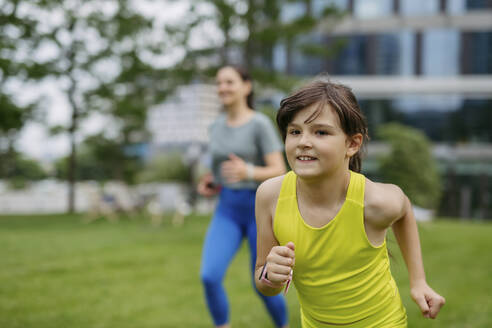 Mother and daughter jogging in the city park. - HAPF03420