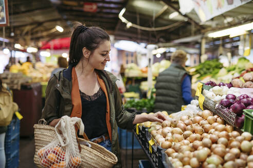 Woman shopping for fresh fruits and vegetables at the city market - HAPF03460
