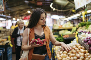 Woman shopping for fresh fruits and vegetables at the city market - HAPF03461
