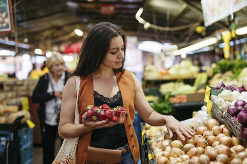 Woman shopping for fresh fruits and vegetables at the city market - HAPF03461