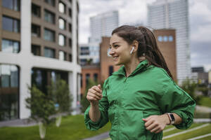 Beautiful woman jogging through the city park - HAPF03466