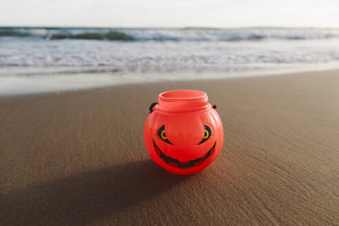 Halloween pumpkin toy on sand at beach - SIF01064