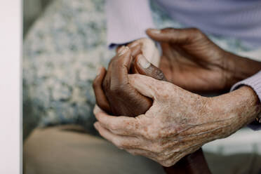 Cropped image of senior man and woman holding hands - MASF40196