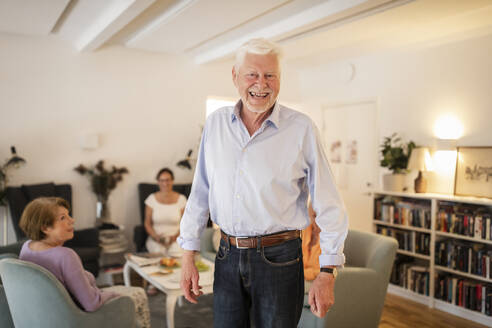 Portrait of happy senior man standing at nursing home - MASF40211