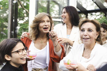 Happy women and boys enjoying summer party at back yard - MASF40424