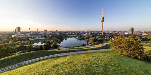 Germany, Bavaria, Munich, Panoramic view of Olympic Park with Olympic Tower, BMW Building and pond in background - WDF07443