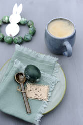 Easter eggs, napkin, teaspoon with label and mug of coffee - GISF00979