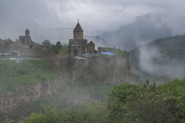 Aerial view of Tatev Monastery on the rocks, a monastery complex with view over the valley and mountains, Tatev, Syunik Province, Armenia. - AAEF22994