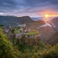 Aerial view of Tatev Monastery on the rocks, a monastery complex with view over the valley and mountains, Tatev, Syunik Province, Armenia. - AAEF22996