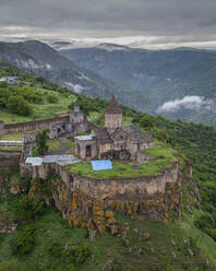 Aerial view of Tatev Monastery on the rocks, a monastery complex with view over the valley and mountains, Tatev, Syunik Province, Armenia. - AAEF22999