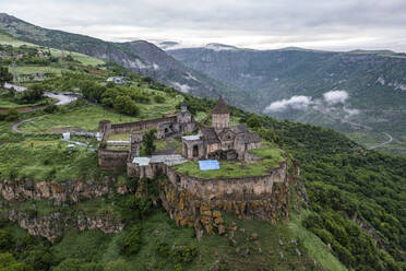 Aerial view of Tatev Monastery on the rocks, a monastery complex with view over the valley and mountains, Tatev, Syunik Province, Armenia. - AAEF23000