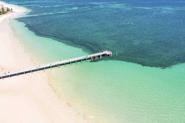 Aerial View Of Jetty Over Turquoise Ocean Water And Coral Reef At Glenelg Beach, South Australia. - AAEF23045