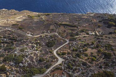 Aerial view of a road along the cliff facing the Ocean in Dingli, Malta. - AAEF23129