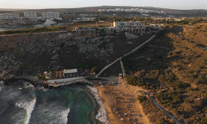 Aerial view of people on Ghajn Beach in Mgarr, Malta. - AAEF23145