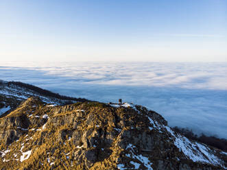 Aerial View of People on Top of Peeshti mountain peak in winter, Valevtsi, Gabrovo, Bulgaria. - AAEF23202