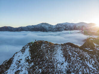 Aerial View of People on Top of Peeshti mountain peak in winter, Valevtsi, Gabrovo, Bulgaria. - AAEF23203