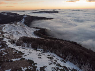 Aerial Panorama View of Snowy Misty Mountain at Sunrise, Peeshti mountain peak in winter, Valevtsi, Gabrovo, Bulgaria. - AAEF23206