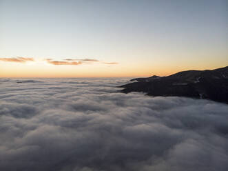 Aerial Mountain View Above Clouds Before Sunrise, Peeshti mountain peak in winter, Valevtsi, Gabrovo, Bulgaria. - AAEF23209