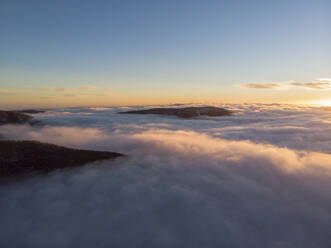 Aerial View Above Clouds of Mountain Range at Sunrise, Peeshti mountain peak in winter, Valevtsi, Gabrovo, Bulgaria. - AAEF23212