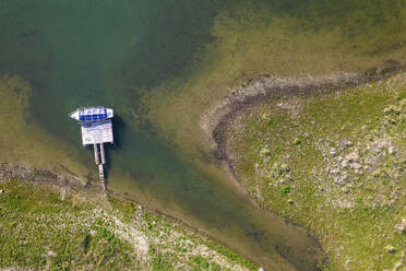 Aerial view of a boat docked along Tsonevo Reservoir, Asparukhovo, Varna, Bulgaria. - AAEF23216