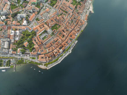 Aerial view of Arona, a small town along the Lago Maggiore (Lake Maggiore) at sunset, Novara, Piedmont, Italy. - AAEF23330