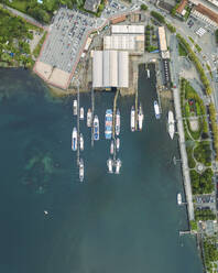 Aerial view of a shipyard in Arona, a small town along the Lago Maggiore (Lake Maggiore) at sunset, Novara, Piedmont, Italy. - AAEF23332