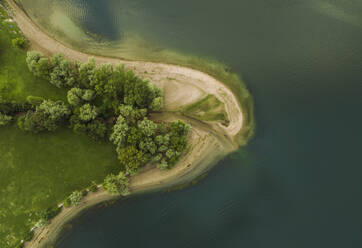 Aerial view of trees with park along the shore at Lago Maggiore (Lake Maggiore) at sunset, Novara, Piedmont, Italy. - AAEF23334