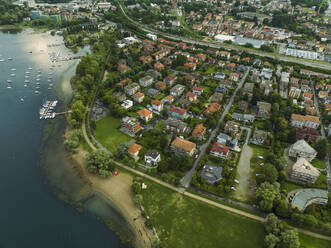 Aerial view of Arona residential area along the Lago Maggiore (Lake Maggiore) at sunset, Novara, Piedmont, Italy. - AAEF23335