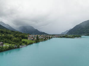Aerial view of Bonigen, a small town along the Brienzersee Lake with rain and low clouds, Canton of Bern, Switzerland. - AAEF23369