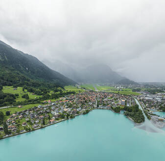 Aerial view of Bonigen, a small town along the Brienzersee Lake with rain and low clouds, Canton of Bern, Switzerland. - AAEF23370