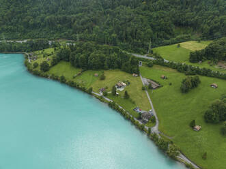 Aerial view of Brienzersee Lake in summertime during a rainy day with low clouds, Bonigen, Bern, Switzerland. - AAEF23373