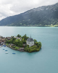 Aerial view of Iseltwald, a small town along the Brienzersee Lake coastline in summertime with rain and low clouds, Bern, Switzerland. - AAEF23384