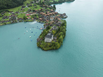 Aerial view of Iseltwald, a small town along the Brienzersee Lake coastline in summertime with rain and low clouds, Bern, Switzerland. - AAEF23386