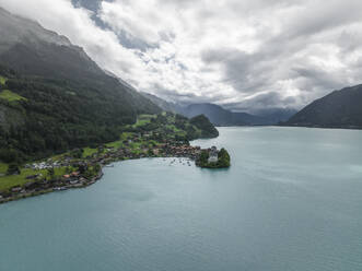 Aerial view of Iseltwald, a small town along the Brienzersee Lake coastline in summertime with rain and low clouds, Bern, Switzerland. - AAEF23387